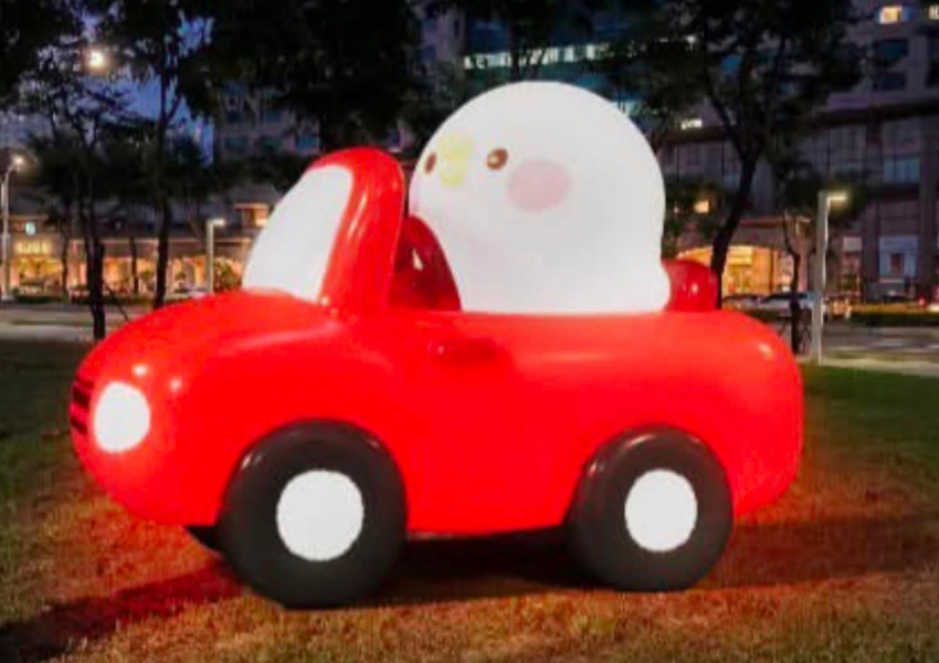 P助乘坐紅色車子造型的耶誕裝置。